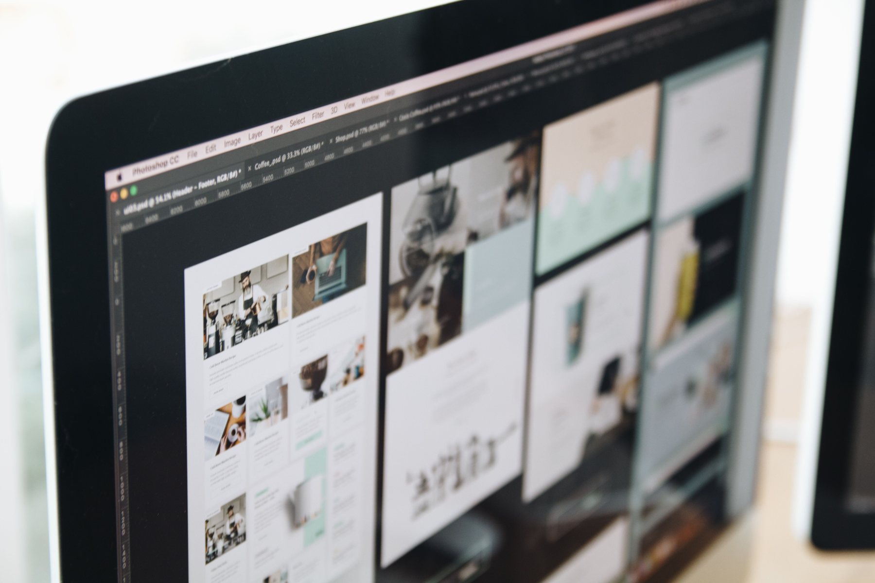 Website layouts being designed on a desktop display